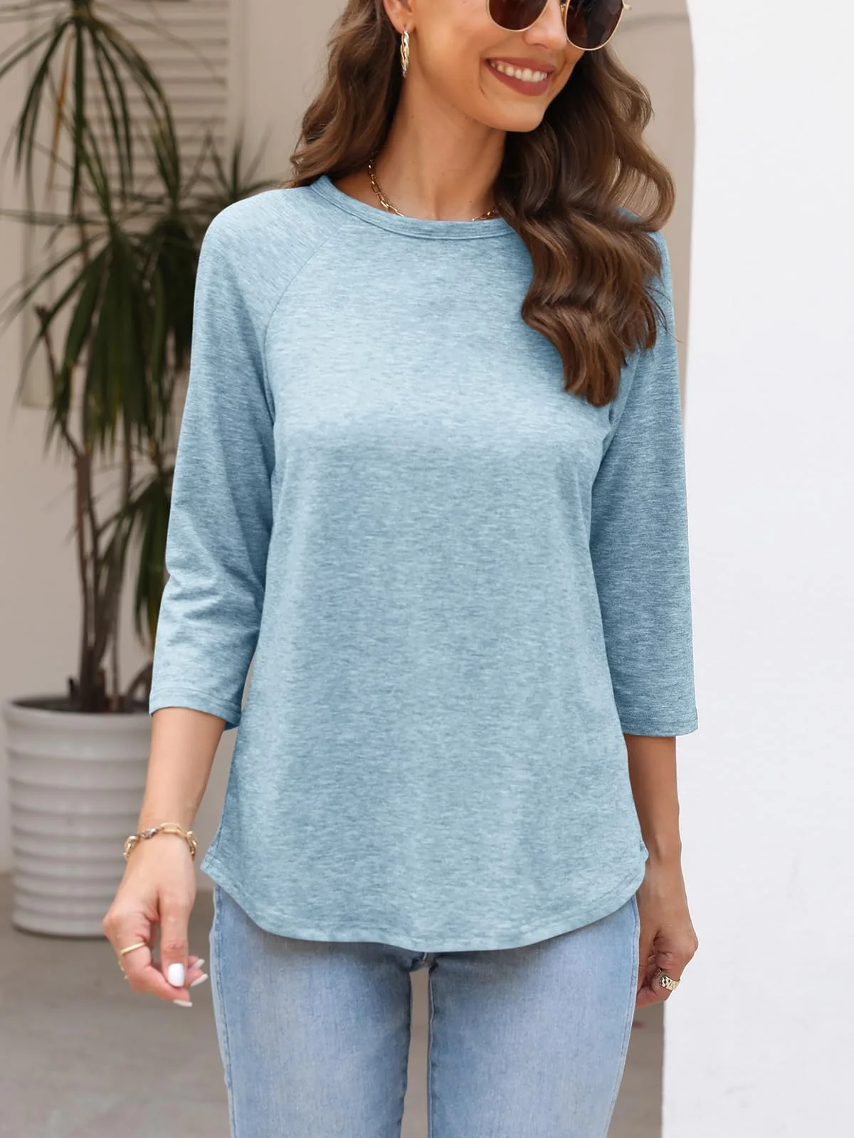 Crewneck 3/4 sleeve raglan tunic in light blue, worn with jeans